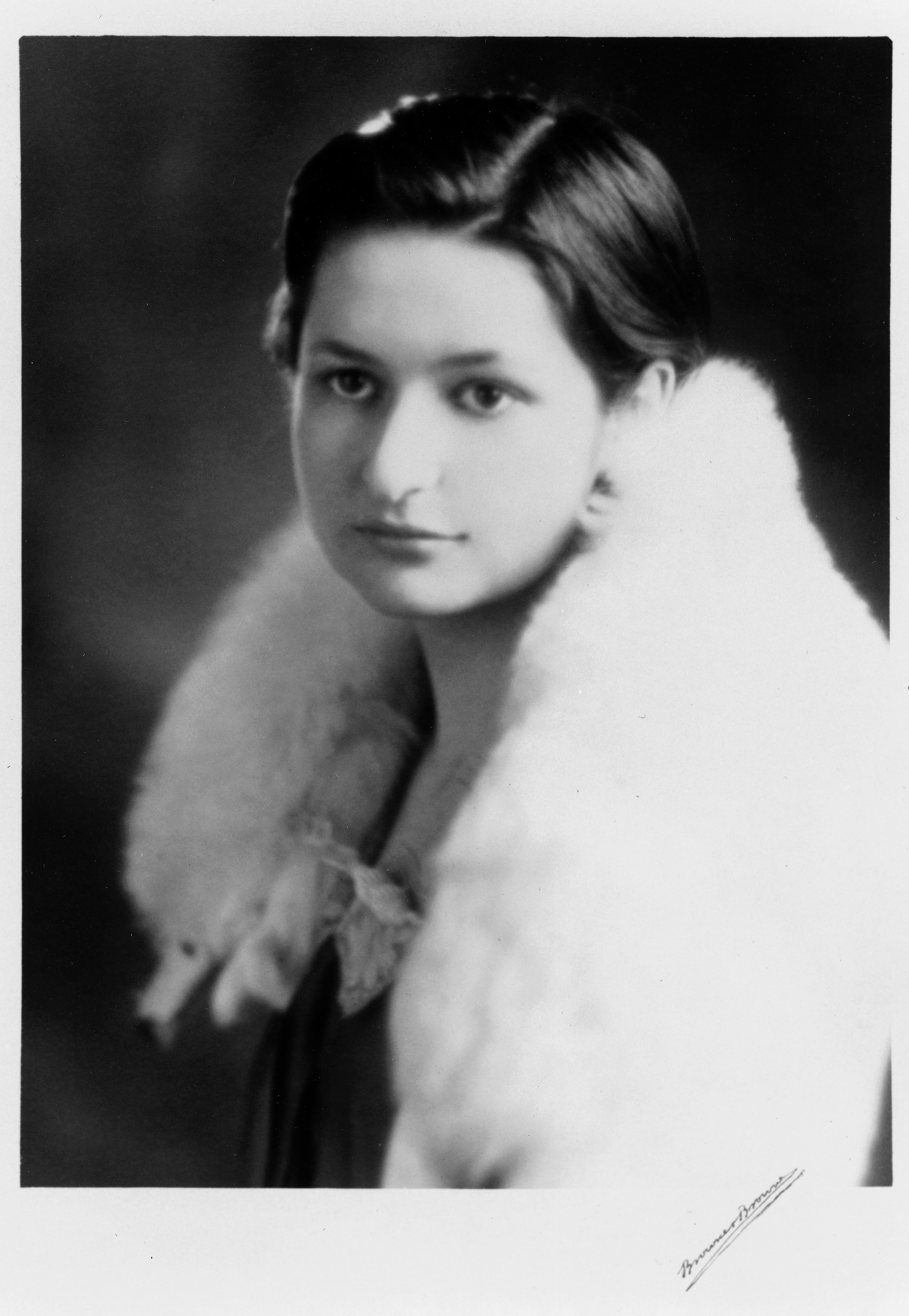 A serious-looking Claudia Taylor at 16 with white fur stole